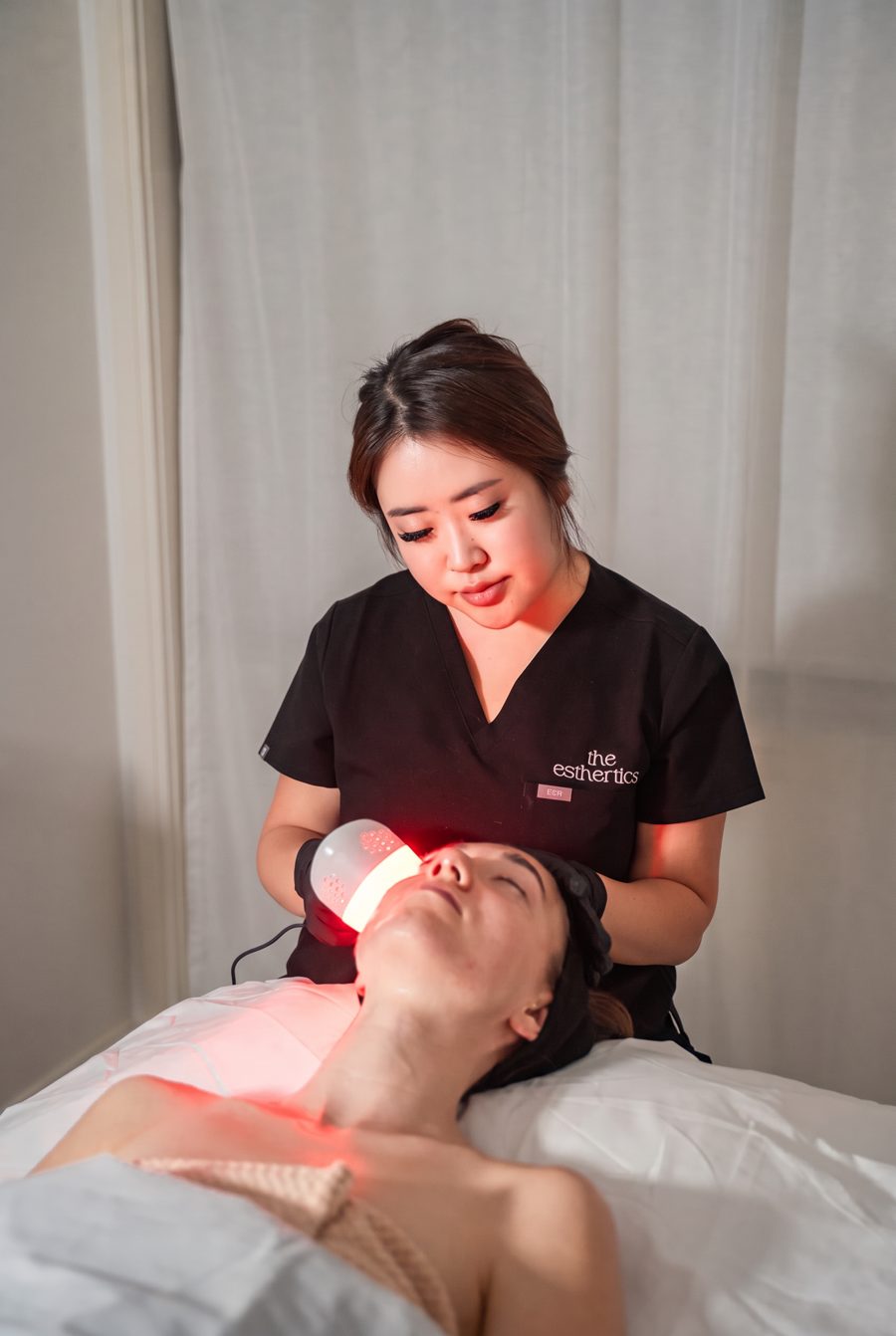 Esther, founder of the esthertics clinic, treating a client in the treatment room